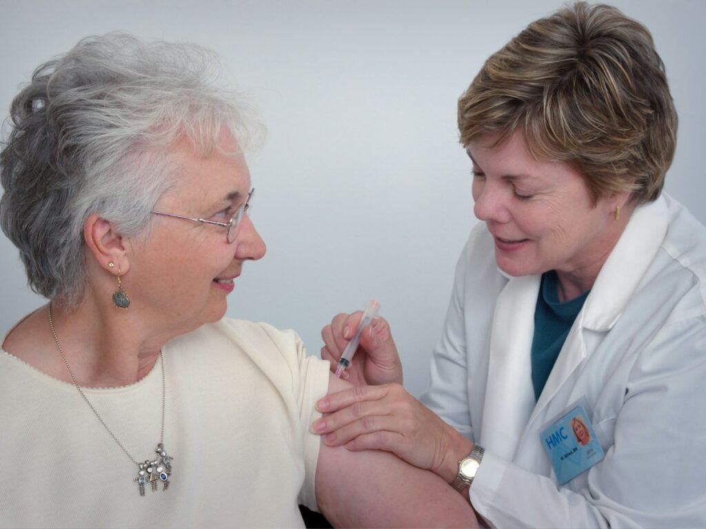 A nurse talks with an older woman during a home visit