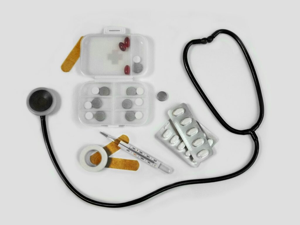 Stethoscope beside medication and a pill organiser